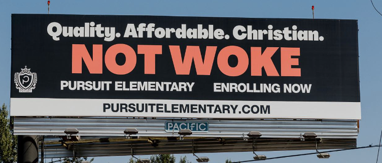 Billboard promoting Pursuit Elementary with statements about being quality, affordable, and Christian, emphasizing 'NOT WOKE' and encouraging enrollment.
